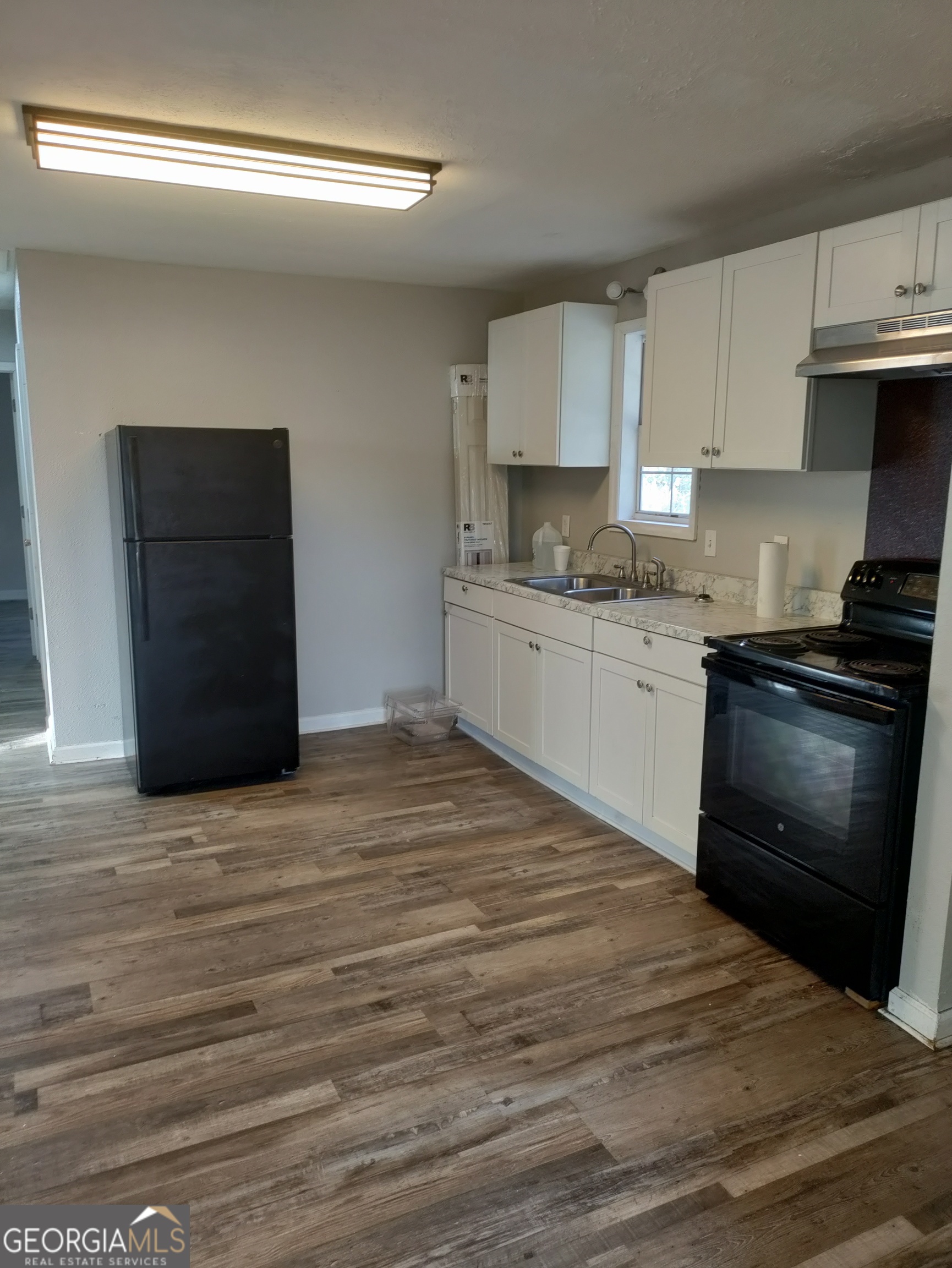 164 Davis Street Southeast Camilla, GA 31730 - Photo 7 of 10 a kitchen with granite countertop cabinets and steel stainless steel appliances
