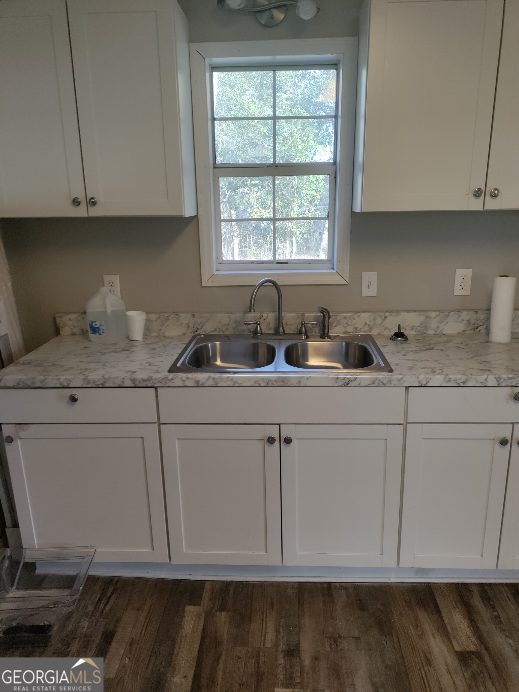 164 Davis Street Southeast Camilla, GA 31730 - Photo 10 of 10 a kitchen with white cabinets and white appliances
