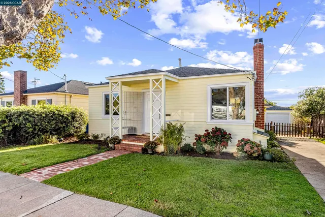 a front view of a house with a garden