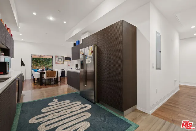 a kitchen with stainless steel appliances granite countertop a refrigerator and a sink