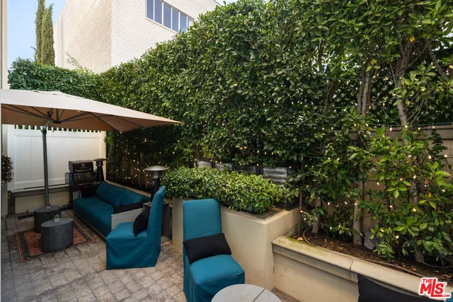 a view of a patio with couches and potted plants