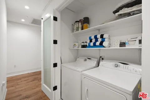 a view of storage and utility room with washer and dryer