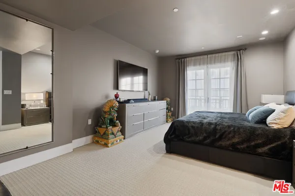 a bedroom with furniture and a window