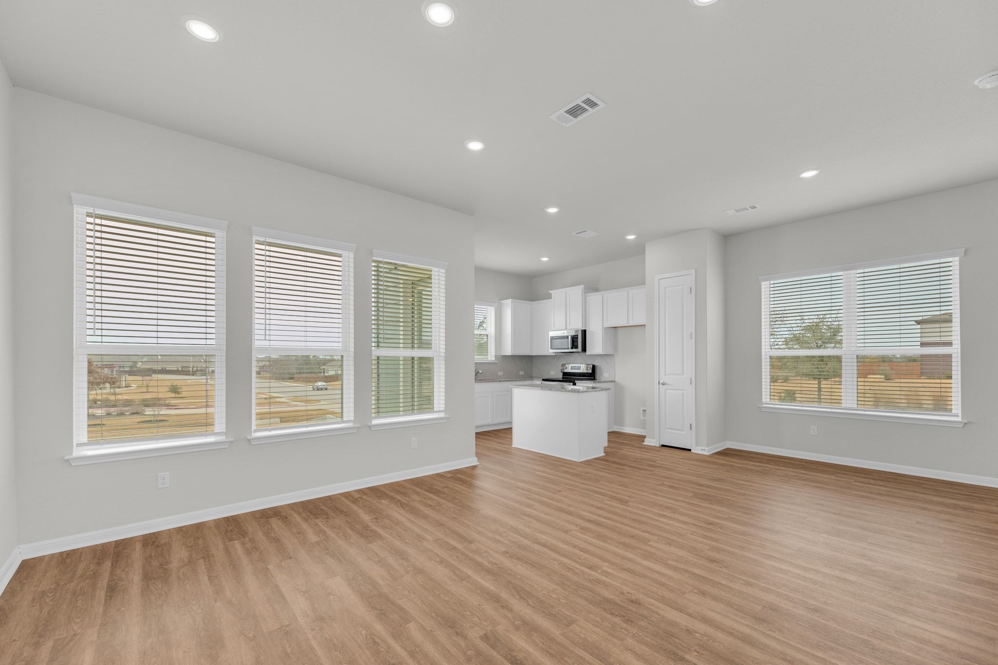 1015 Vista View Drive, Unit 101 Georgetown, TX 78626 - Photo 4 of 40 Unfurnished living room featuring light wood-style floors and recessed lighting
