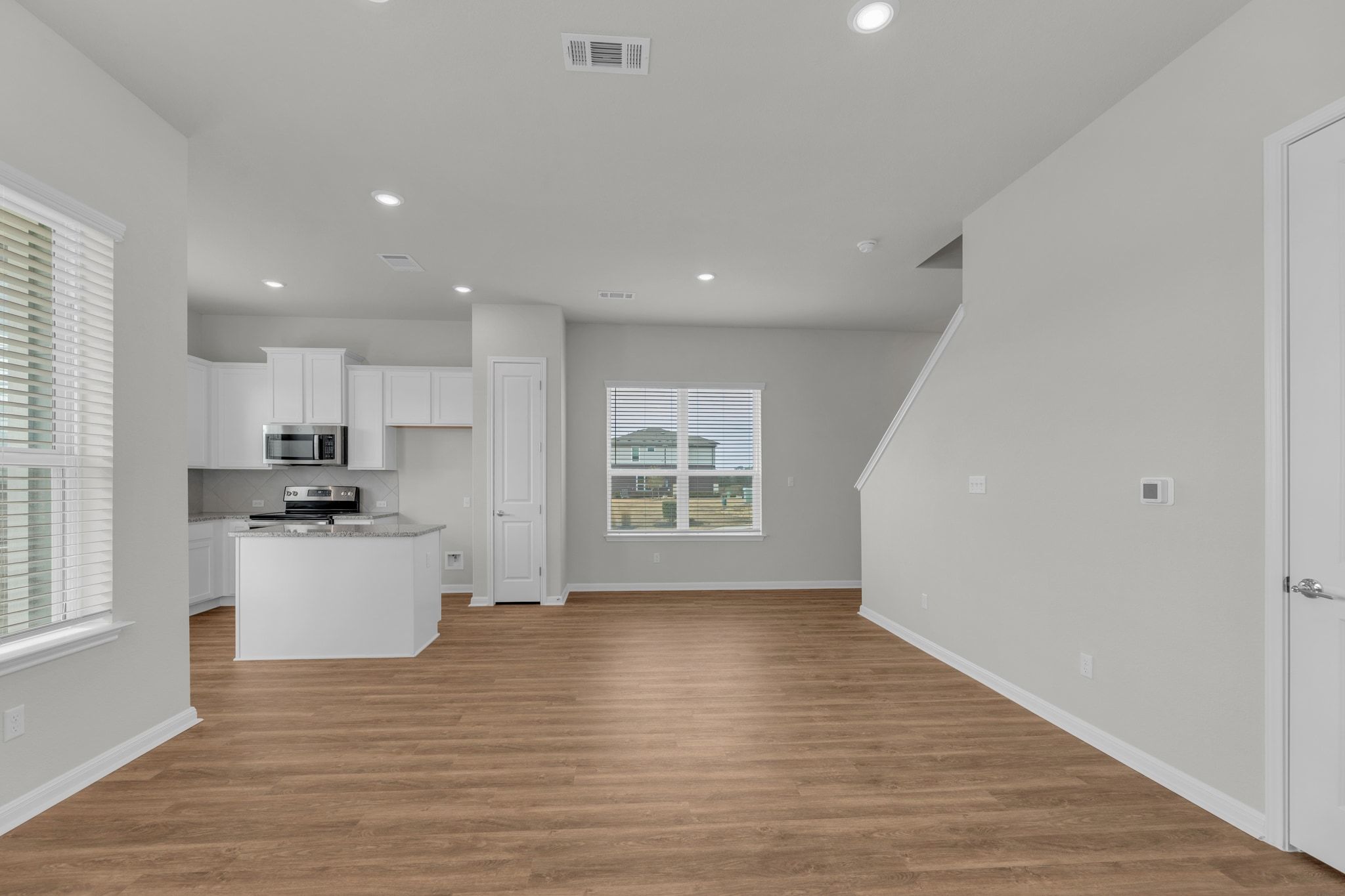 1015 Vista View Drive, Unit 101 Georgetown, TX 78626 - Photo 5 of 40 Kitchen with white cabinets, a center island, light wood-style floors, recessed lighting, and stainless steel appliances