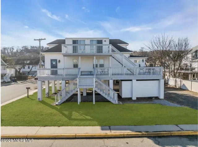 a view of a house with a yard and sitting area