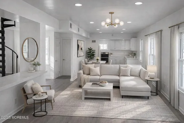 a living room with furniture and a chandelier