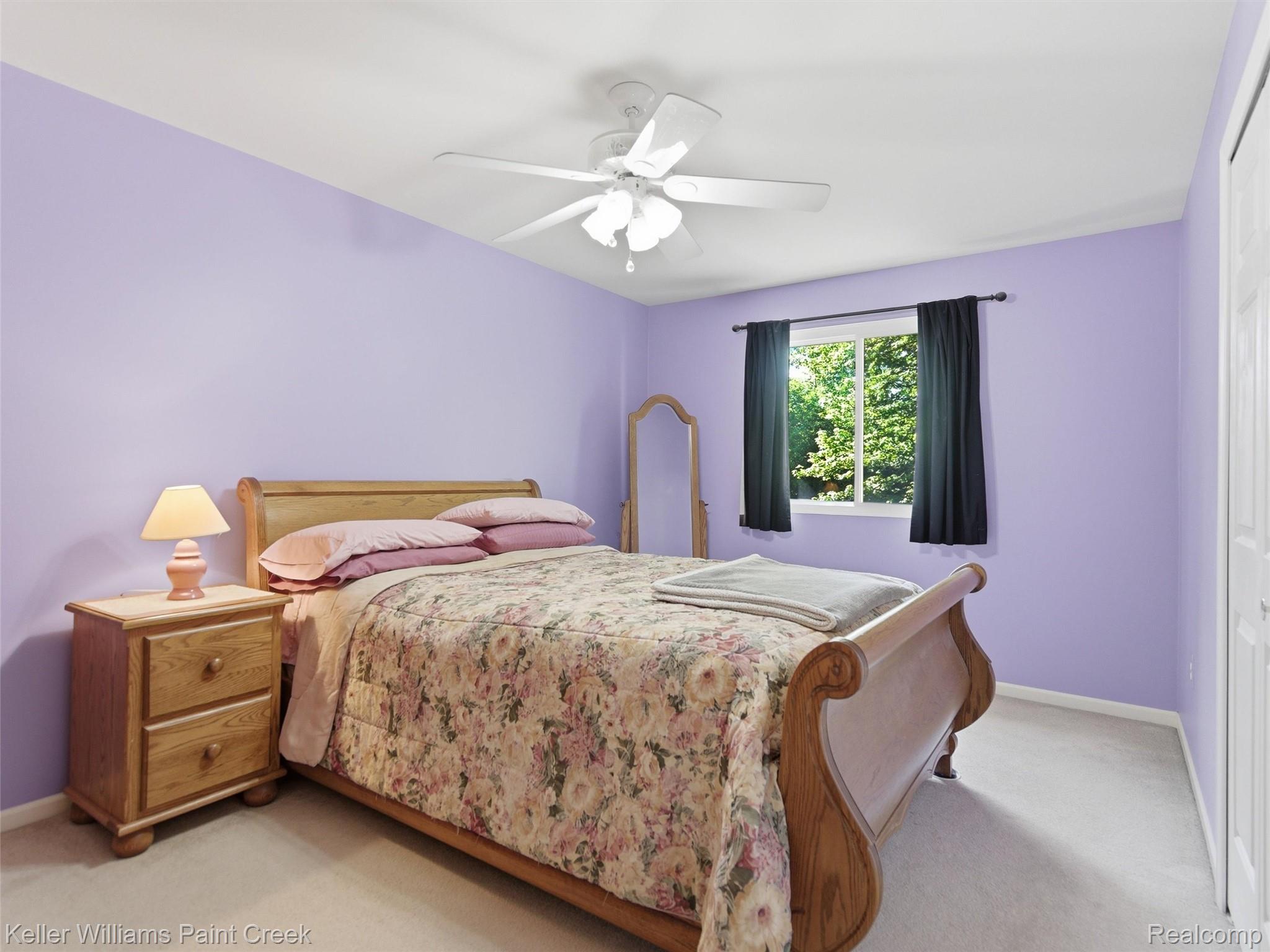 2842 Manorwood Road Troy, MI 48085 - Photo 53 of 72 Light-filled room featuring a ceiling fan, a window with exterior views, and neutral carpet flooring