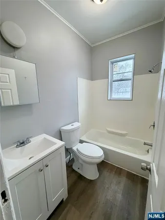 a white toilet sitting next to a bathroom sink