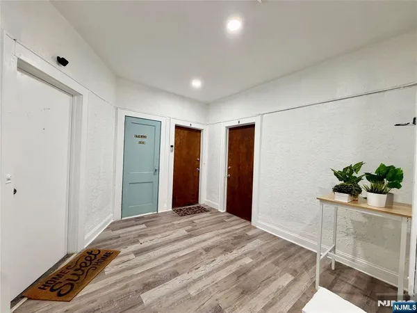 a bedroom with a bed and a potted plant