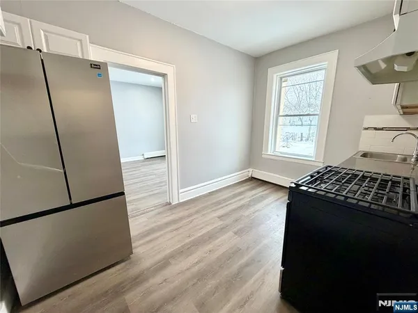 a kitchen with a refrigerator and a window