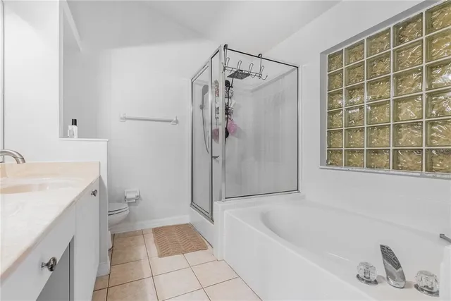 a bathroom with a tub a sink and a shower