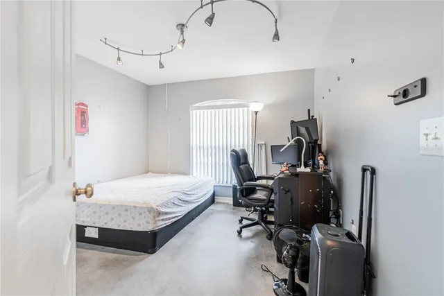 a bedroom that has a bed and a chair in it