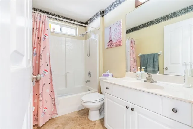 a bathroom with a sink a toilet and a large mirror