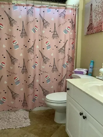 a white toilet sitting next to a bathroom sink