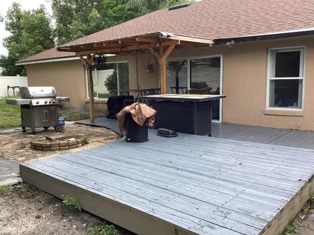 a view of a backyard with sitting area