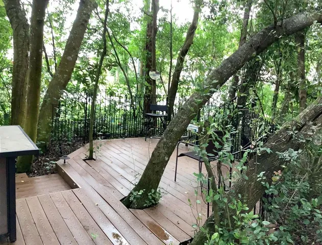 a wooden floor with trees in front of it