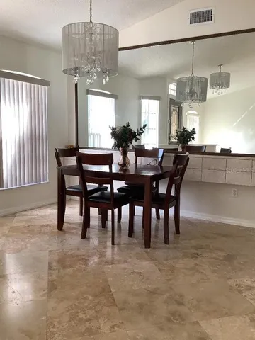 a view of a dining room with furniture window and outside view