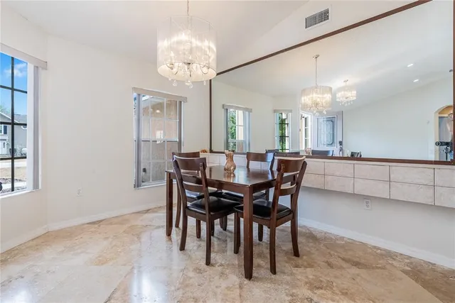 a view of a dining room with furniture and chandelier