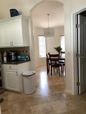 a kitchen with sink and refrigerator