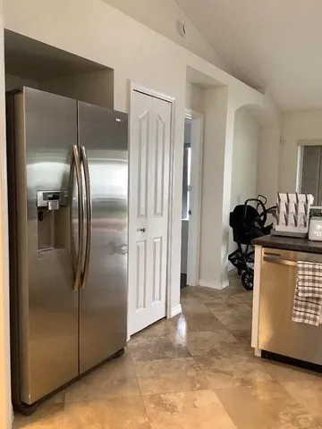a metallic refrigerator freezer sitting in a kitchen