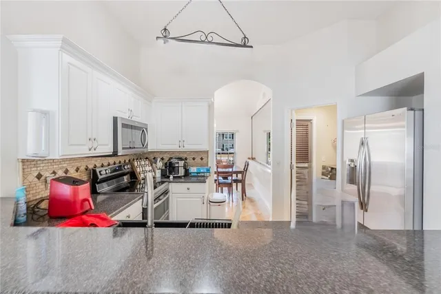 a living room with furniture a flat screen tv and a table
