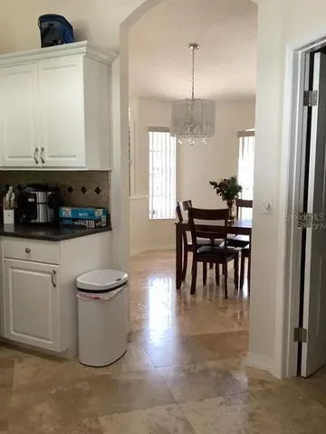 a kitchen with a table and chairs