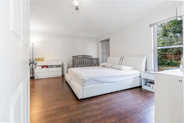 a bedroom with a bed and a large window