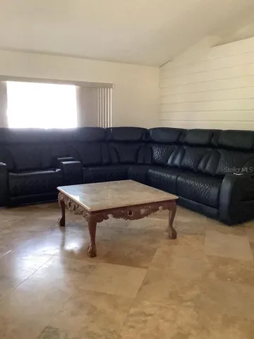 a living room with a couch and a table