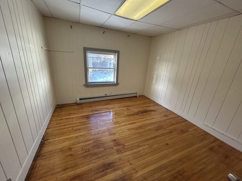 310 Park Worcester Ma, Unit 1 Worcester, MA 01609 - Photo 8 of 11 an empty room with wooden floor and windows
