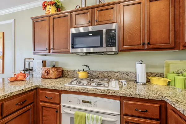 a kitchen with stainless steel appliances a stove a sink a refrigerator and cabinets