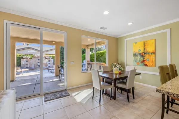 a large kitchen with a table and chairs