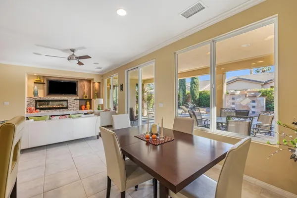 a living room with stainless steel appliances kitchen island furniture a rug and a view of kitchen