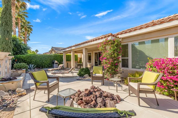a view of a patio with table and chairs and potted plants
