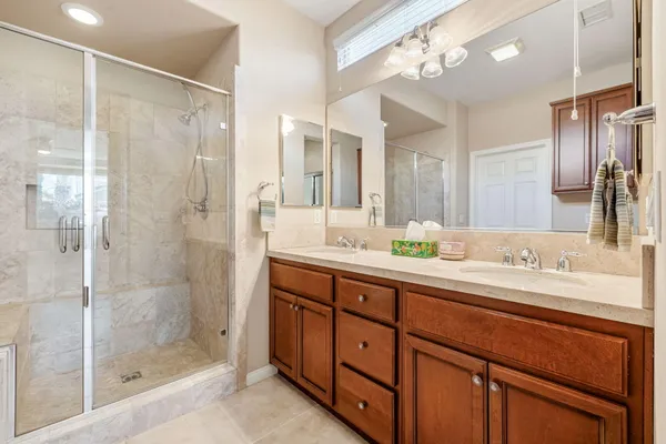 a bathroom with a shower sink and mirror