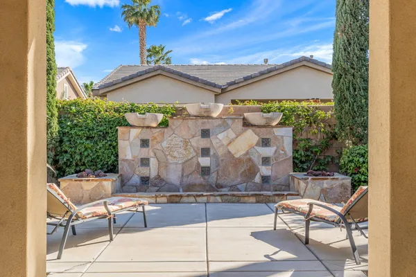 a view of a patio with a dining table and chairs