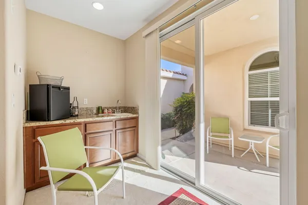 a kitchen with a dining table chairs and entryway