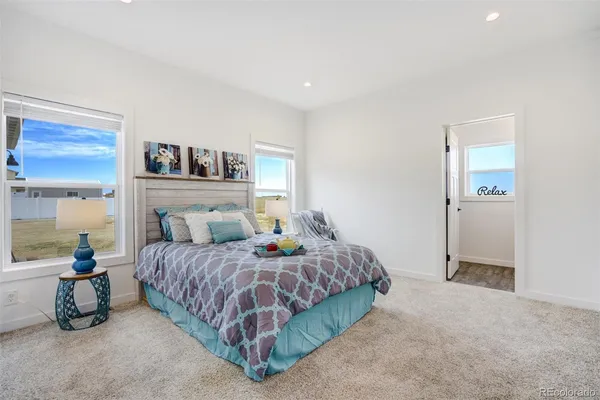 a bedroom with a bed and a lamp