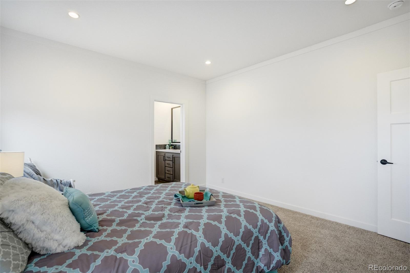 1684 9th Street Limon, CO 80828 - Photo 14 of 39 a bedroom with a bed and a lamp