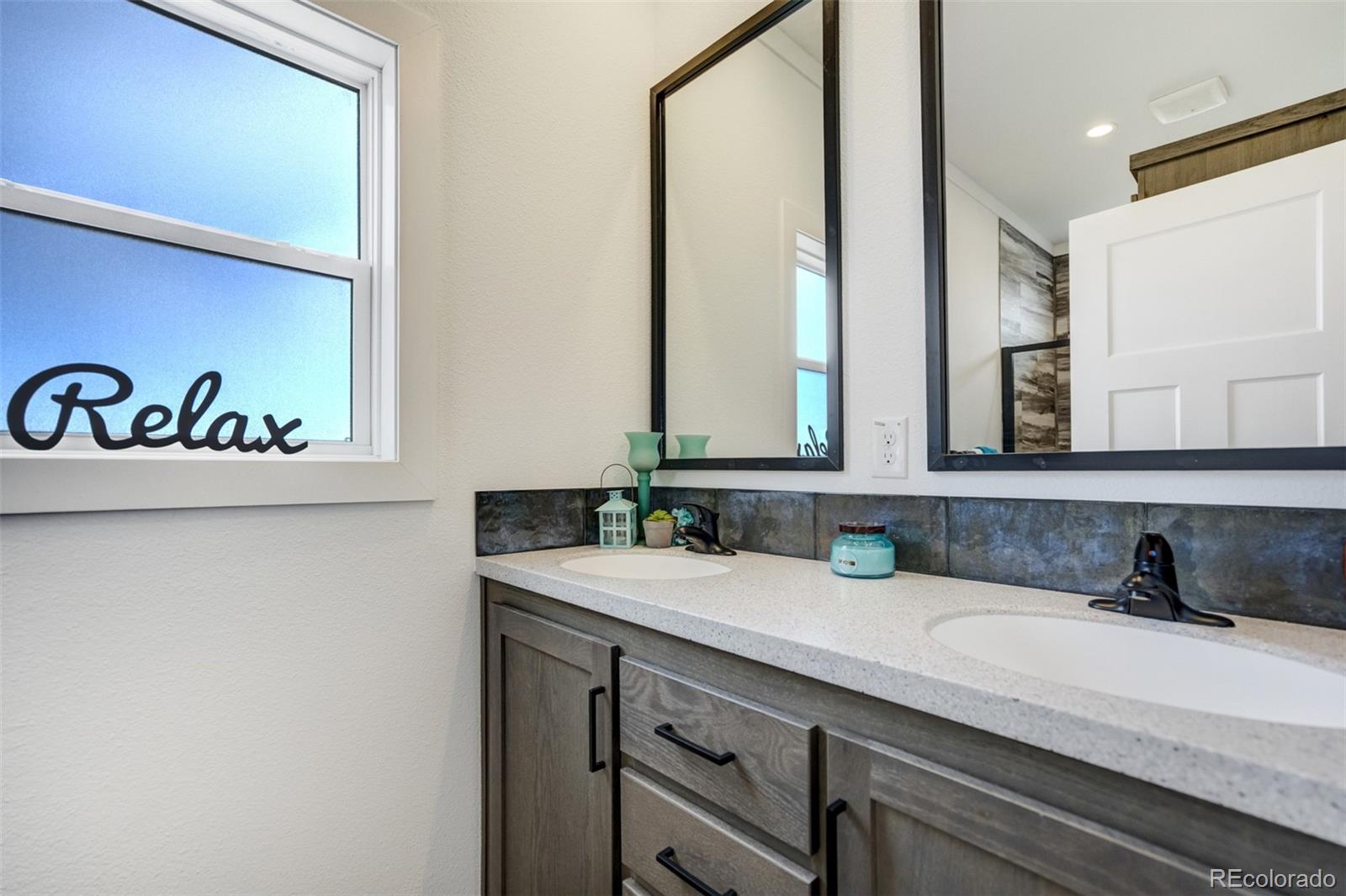 1684 9th Street Limon, CO 80828 - Photo 15 of 39 a bathroom with a sink and a mirror