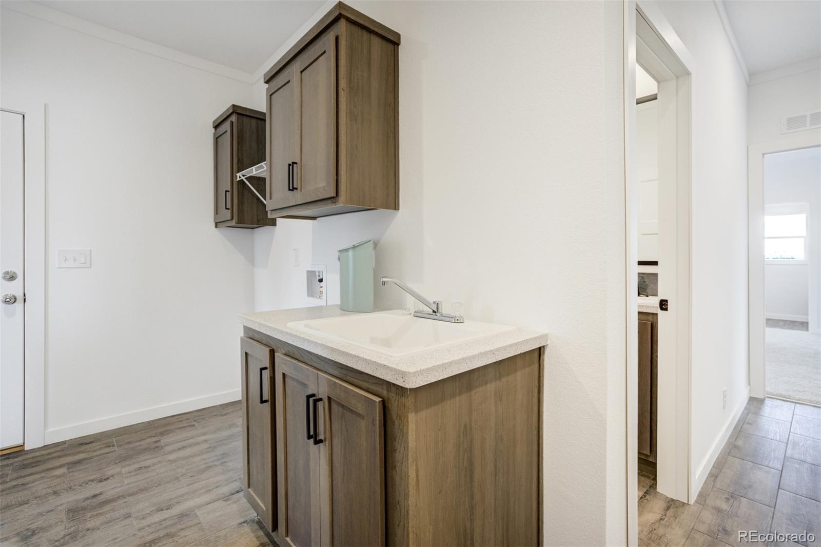 1684 9th Street Limon, CO 80828 - Photo 22 of 39 a utility room with a sink dryer and washer