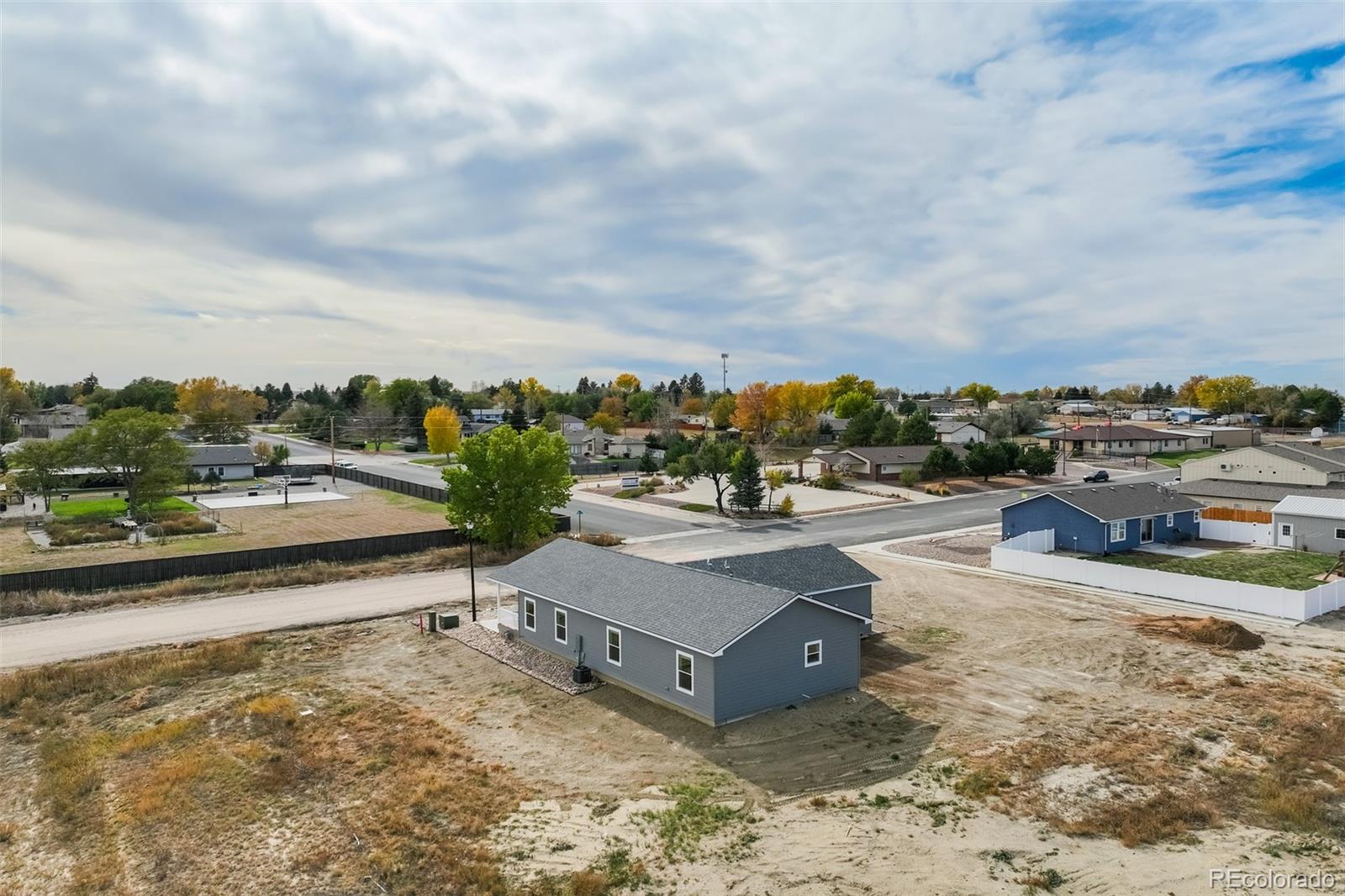 1684 9th Street Limon, CO 80828 - Photo 29 of 39 a view of a swimming pool with a lawn chairs and a big yard