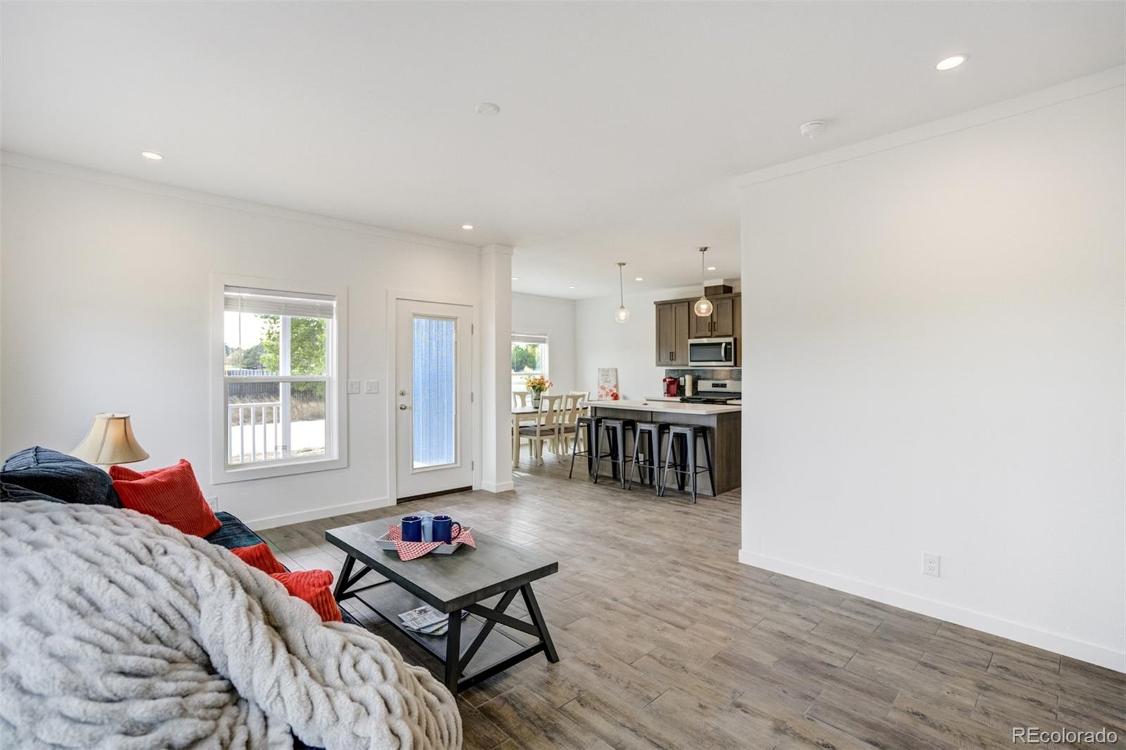 1684 9th Street Limon, CO 80828 - Photo 31 of 39 a living room with furniture a bed and a window