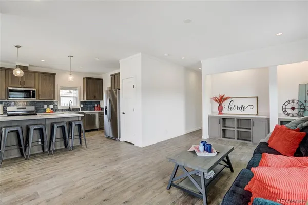 a living room with furniture and kitchen view
