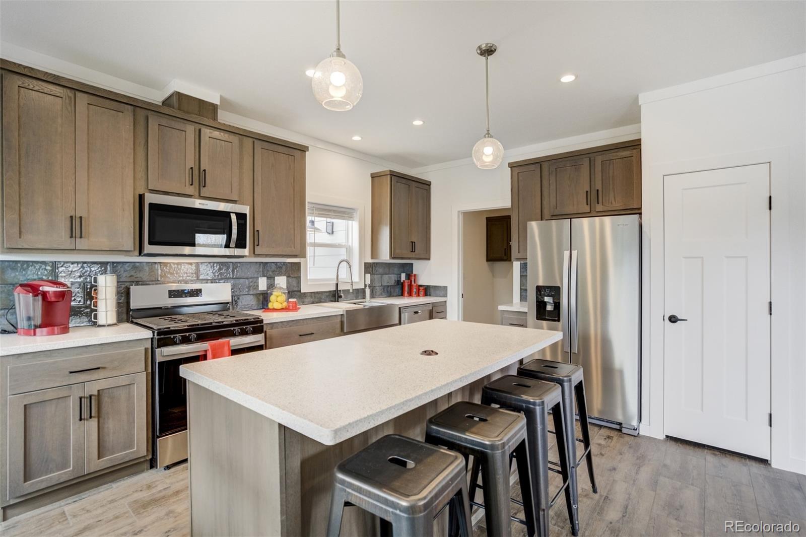 1684 9th Street Limon, CO 80828 - Photo 9 of 39 a kitchen that has a table chairs appliances and wooden cabinets