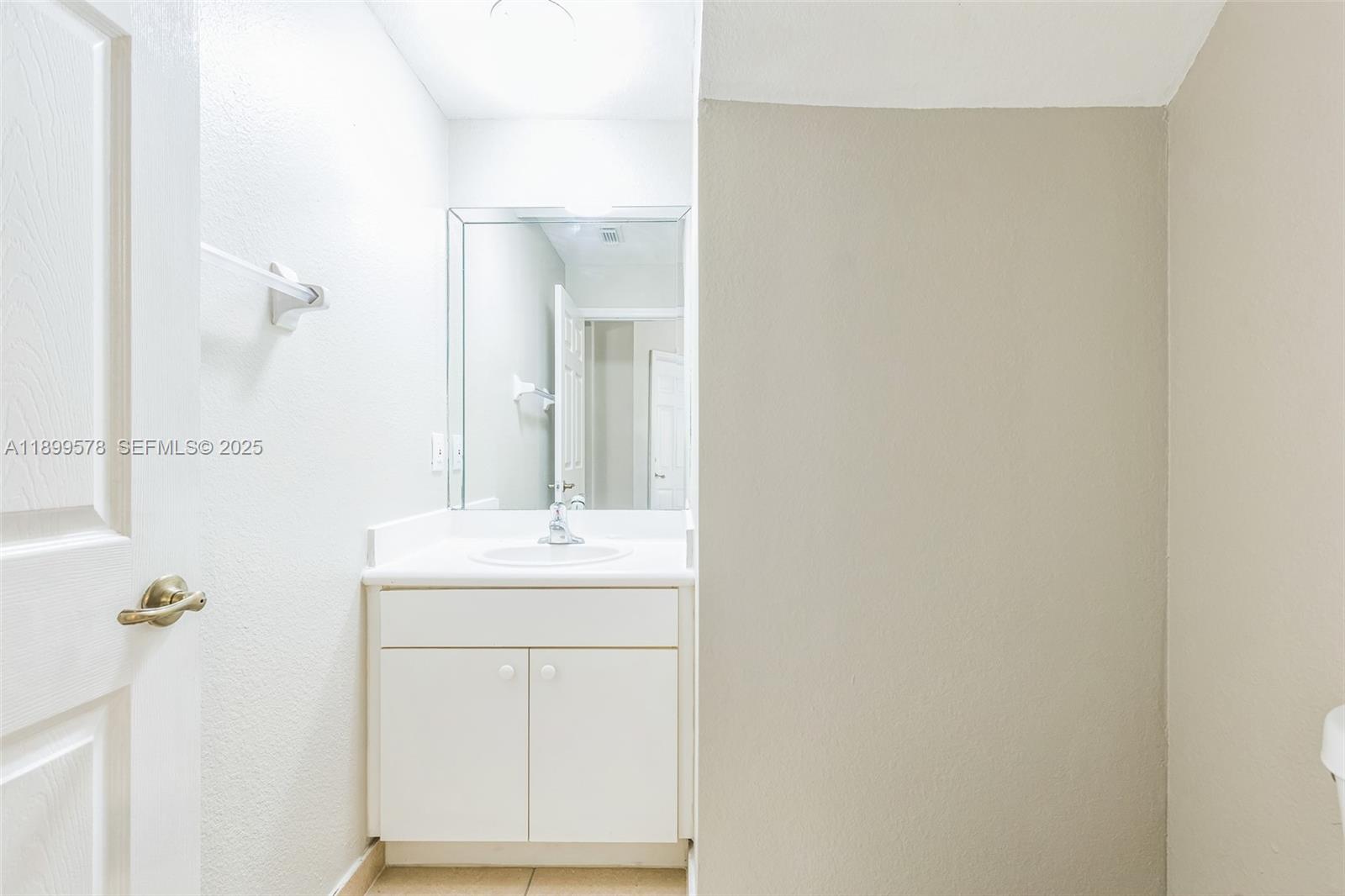 24066 Southwest 109th Court Homestead, FL 33032 - Photo 14 of 37 a bathroom with a sink a mirror and a shower