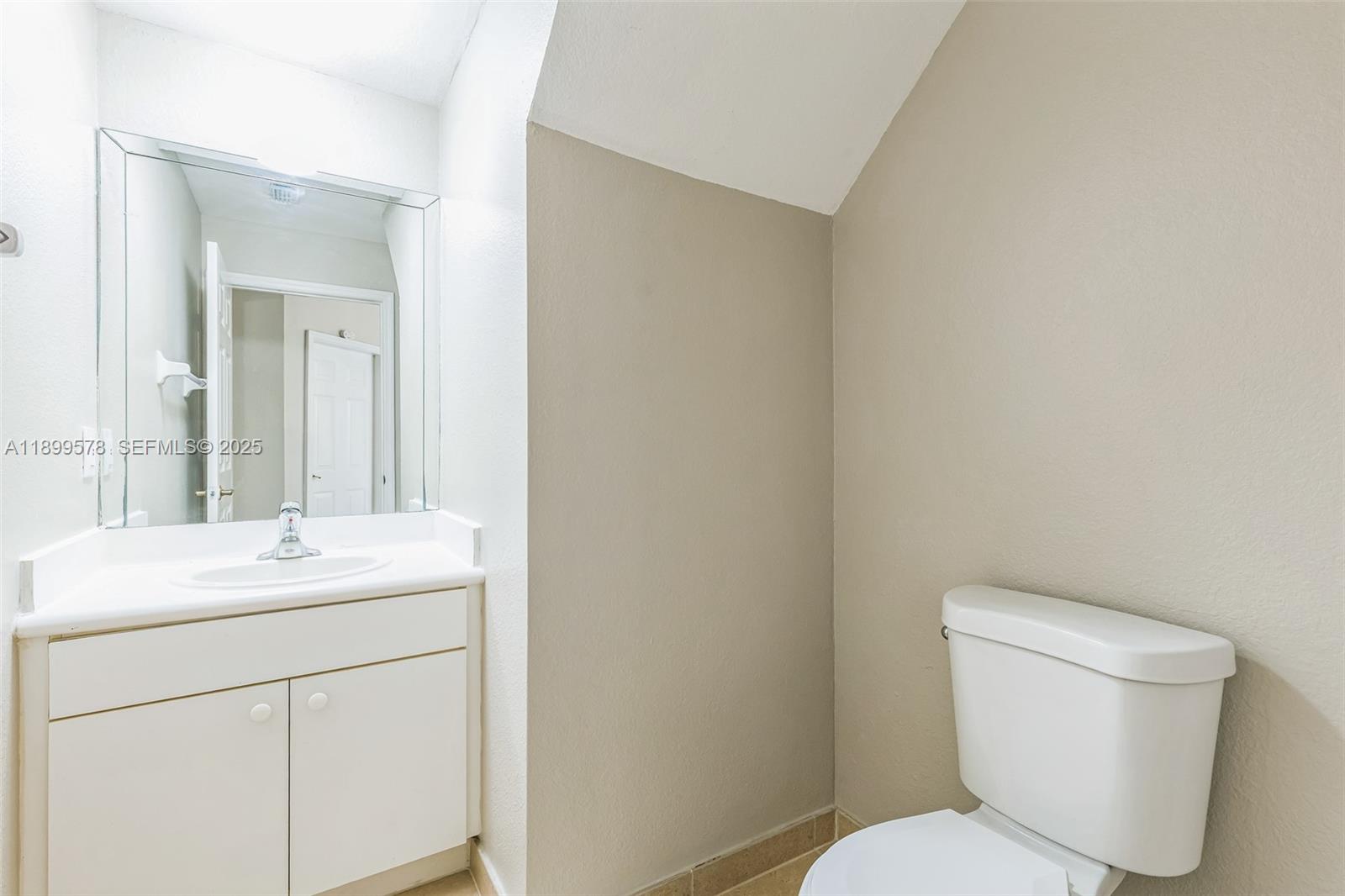 24066 Southwest 109th Court Homestead, FL 33032 - Photo 15 of 37 a bathroom with a toilet sink and mirror