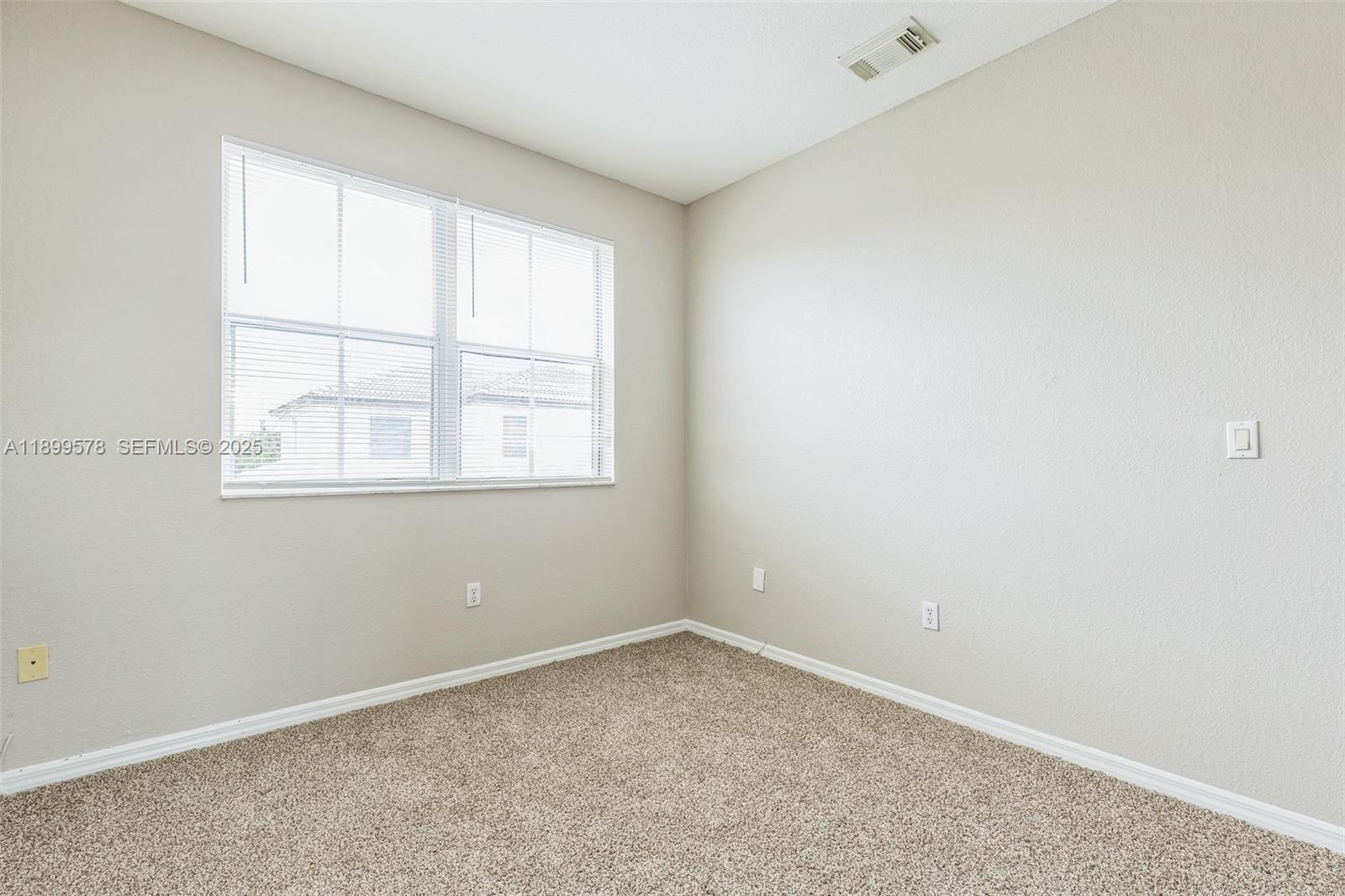 24066 Southwest 109th Court Homestead, FL 33032 - Photo 23 of 37 an empty room with a window
