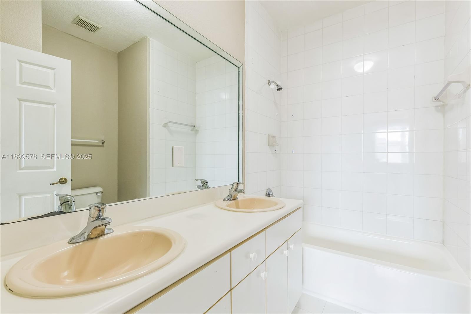 24066 Southwest 109th Court Homestead, FL 33032 - Photo 25 of 37 a bathroom with a sink and a mirror