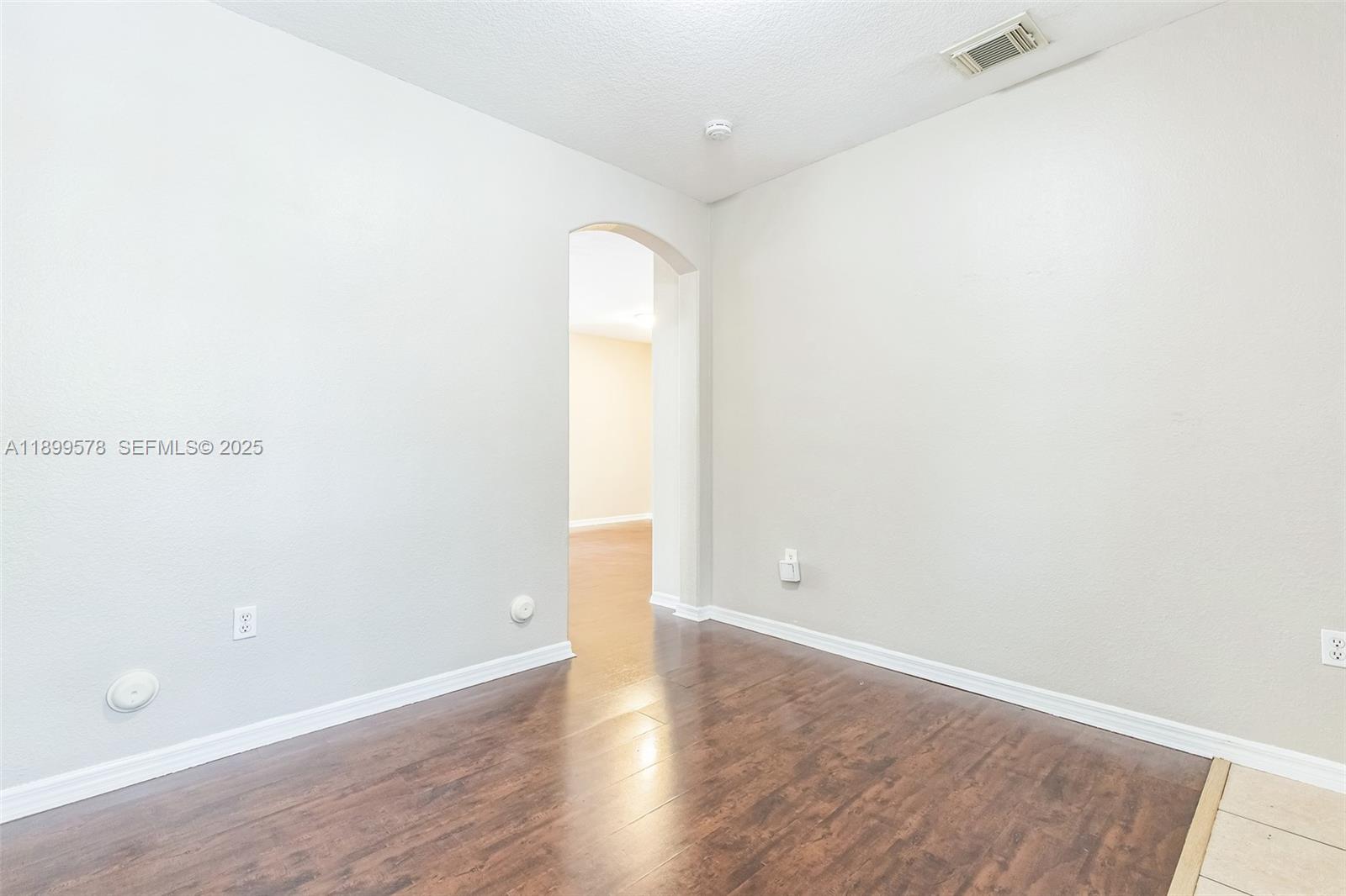 24066 Southwest 109th Court Homestead, FL 33032 - Photo 26 of 37 a view of an empty room with wooden floor